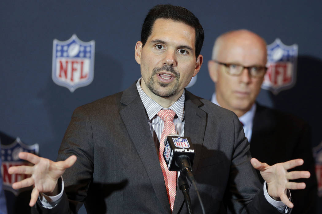 In this Monday, March 24, 2014, file photo, NFL vice president of officiating Dean Blandino speaks during a news conference, while Atlanta Falcons President, CEO and NFL competition committee memb ...