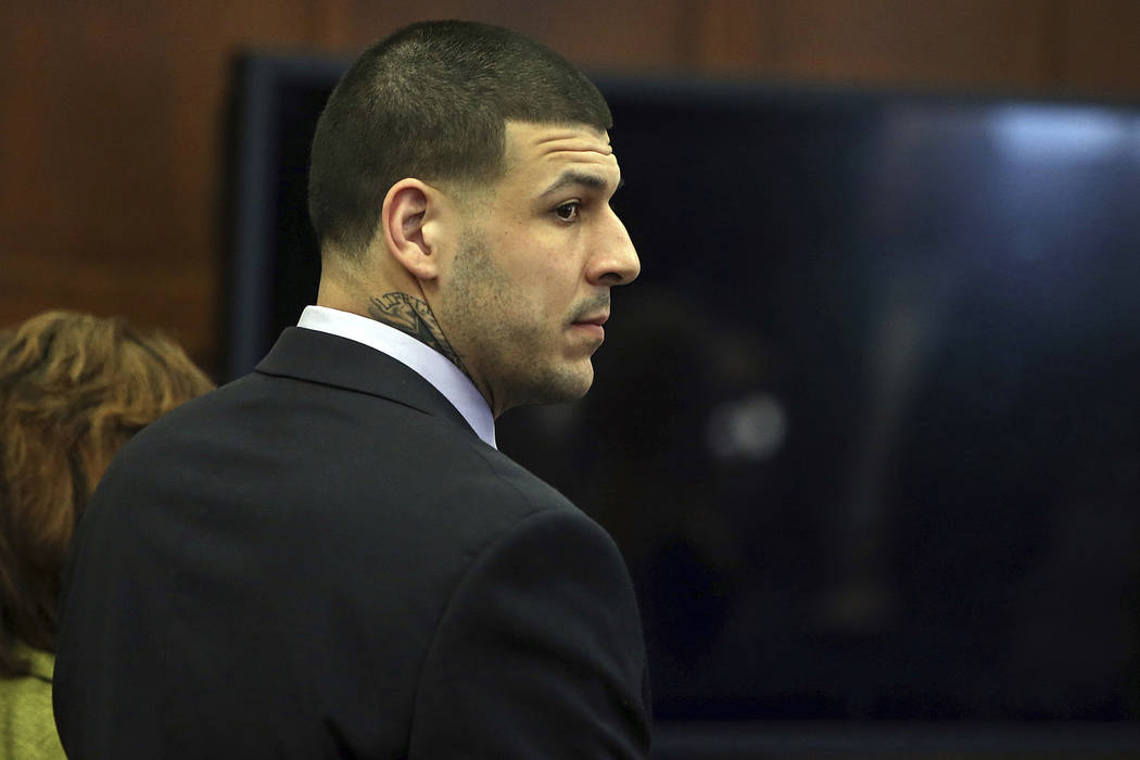 Former New England Patriots tight end Aaron Hernandez stands at the defense table when court is adjourned without a verdict on day five of jury deliberations in his double murder trial at Suffolk  ...