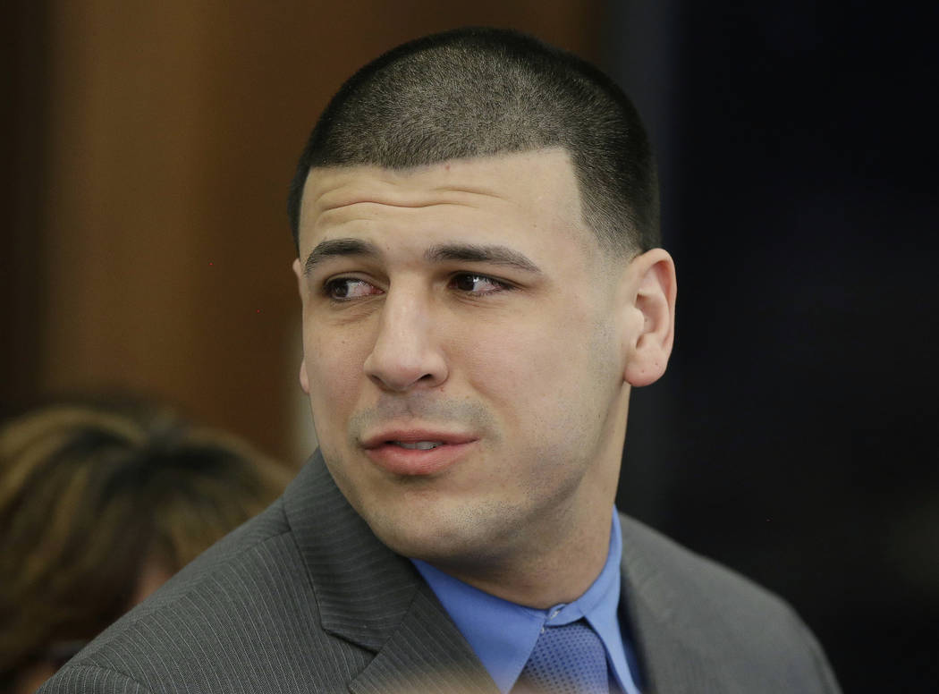Former New England Patriots tight end Aaron Hernandez turns to look toward his fiancee Shayanna Jenkins Hernandez as he reacts to his double murder acquittal at Suffolk Superior Court Friday, Apri ...