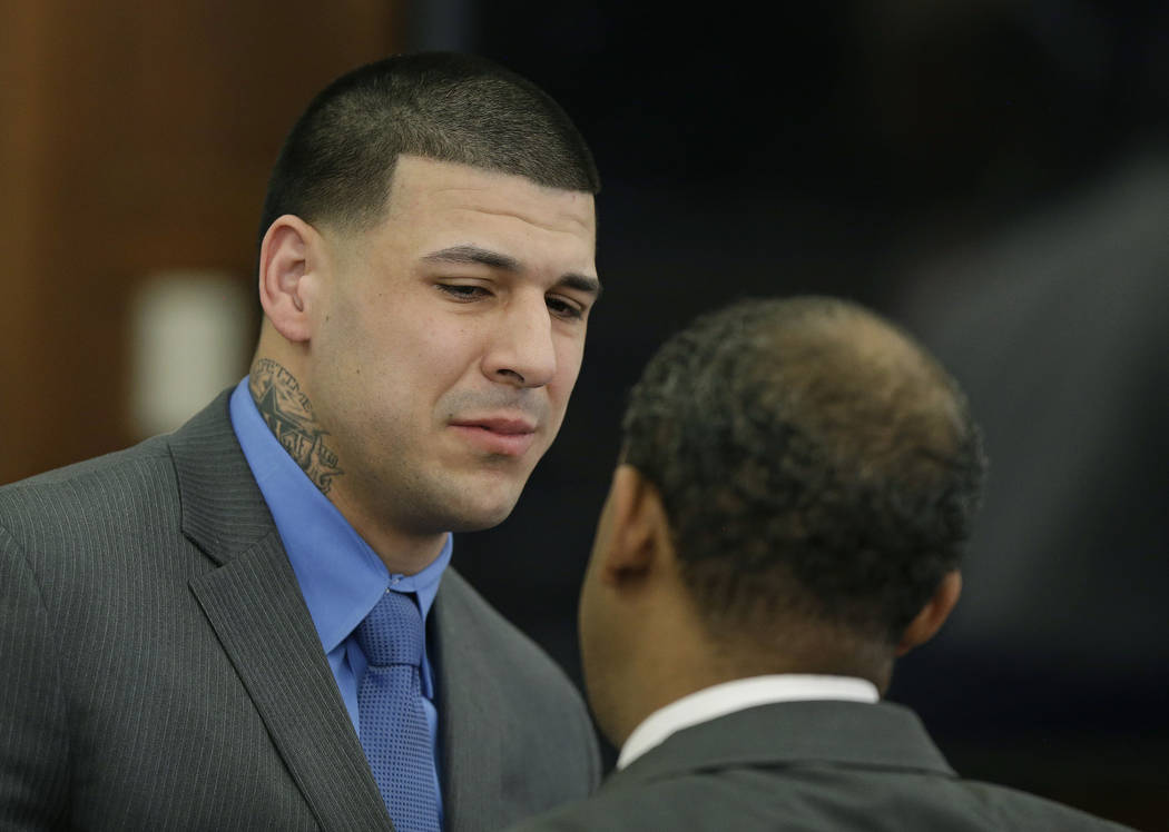 Former New England Patriots tight end Aaron Hernandez cries as he turns to defense attorney Ronald Sullivan reacting to his double murder acquittal at Suffolk Superior Court Friday, April 14, 2017 ...