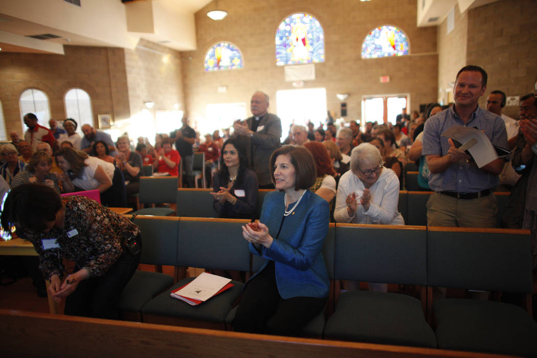 U.S. Senator Catherine Cortez Masto, D-Nev., center, applauds with the crowd an immigration forum hosted by the Nevadans for the Common Good on Monday, April 17, 2017, at the All Saints Episcopal  ...
