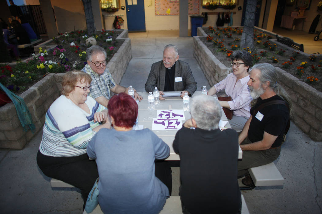A group led by Father Jamie Conrad, center, discusses personal immigration or migration stories after an immigration forum hosted by the Nevadans for the Common Good on Monday, April 17, 2017, at  ...
