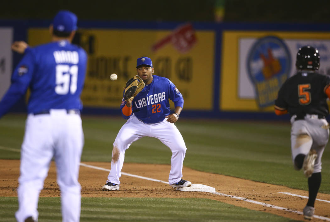 Las Vegas 51s first baseman Dominic Smith (22) catches the throw to get out Fresno Grizzlies infielder Tony Kemp (5) during a baseball game at Cashman Field in Las Vegas on Thursday, April 13, 201 ...