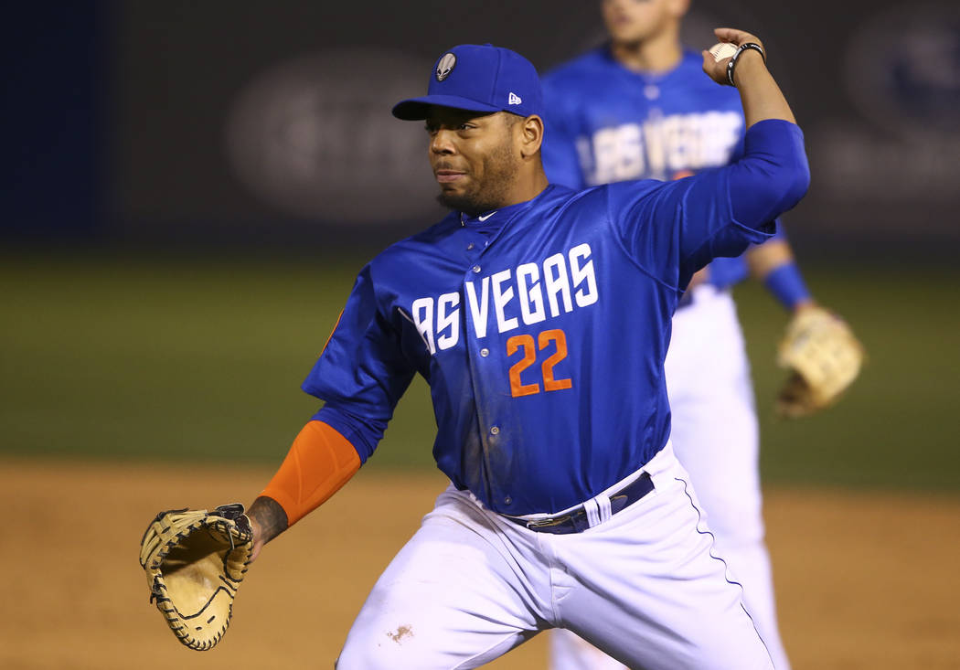 Las Vegas 51s first baseman Dominic Smith (22) throws to home base for the out during a baseball game at Cashman Field in Las Vegas on Thursday, April 13, 2017. Chase Stevens Las Vegas Review-Jour ...