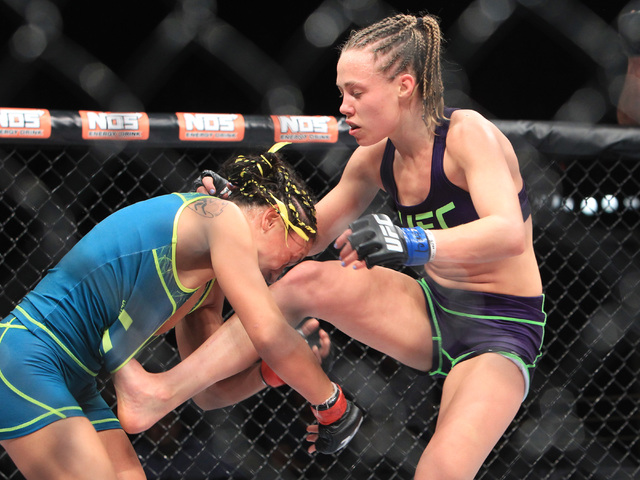 Rose Namajunas gets her foot caught in Carla Esparza's top during their strawweight fight at The Ultimate Fighter finale Friday, Dec. 12, 2014 at the Palms. Esparza became the UFC's first female s ...