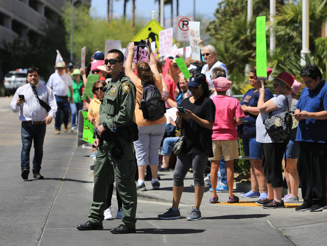 A Las Vegas police officer keeps a driveway clear during a tax day protest at Trump International Hotel on Saturday, April 15, 2017. Brett Le Blanc Las Vegas Review-Journal @bleblancphoto