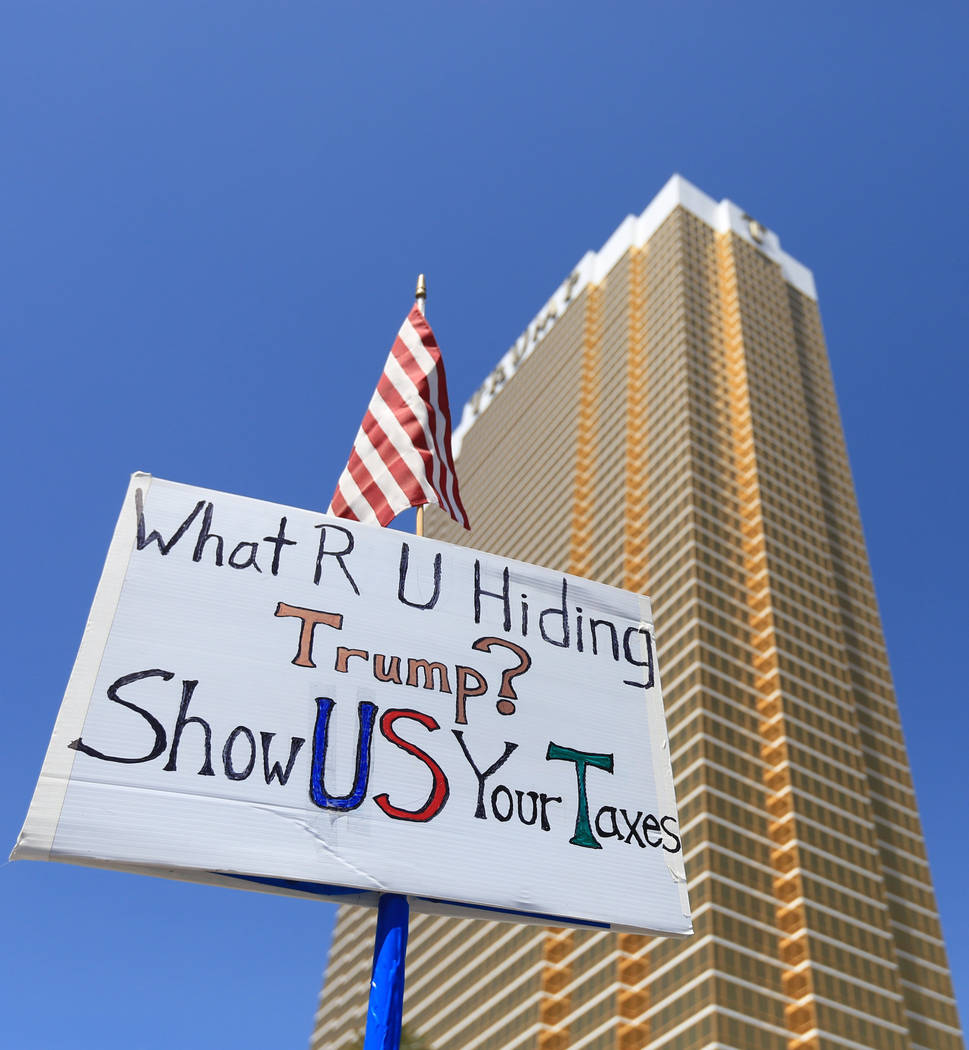 A demonstrator hold a sign asking President Donald Trump to release his tax returns during a tax day protest at Trump International Hotel on Saturday, April 15, 2017. Brett Le Blanc Las Vegas Revi ...