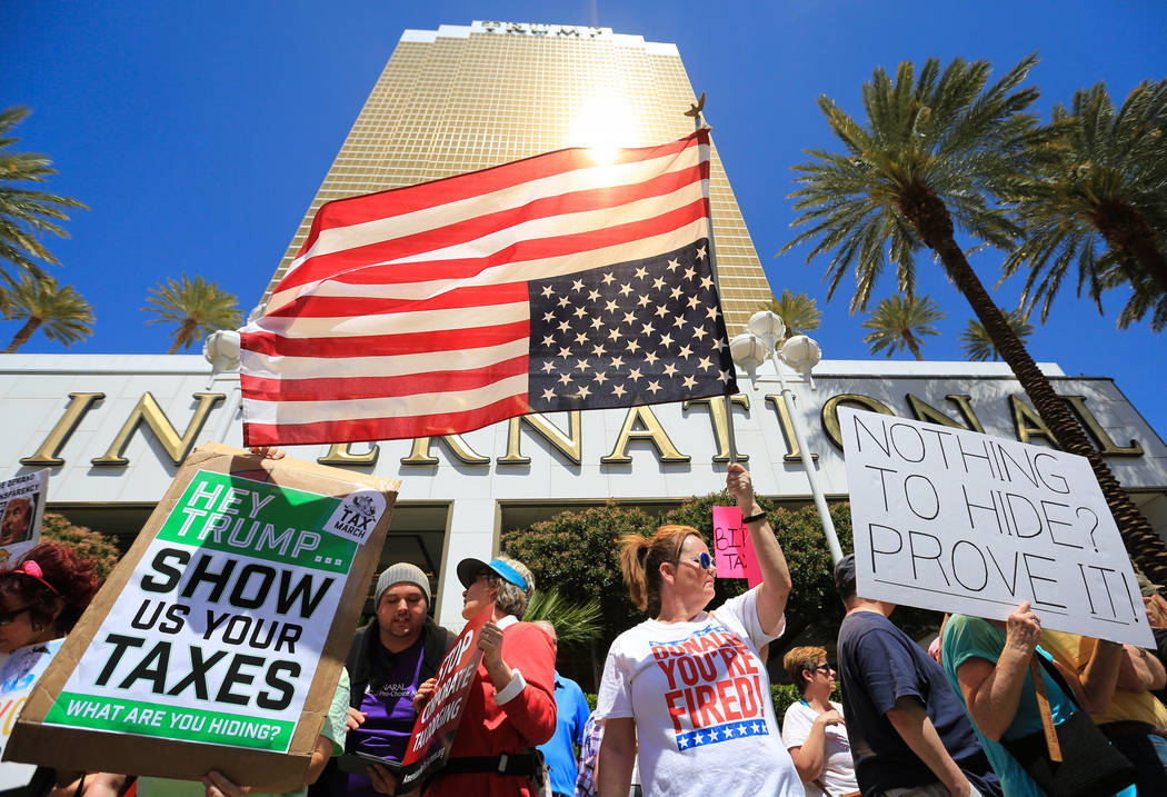 Colleen Brola, center right, holds an upside down American flag during a tax day protest at Trump International Hotel on Saturday, April 15, 2017. Brett Le Blanc Las Vegas Review-Journal @bleblanc ...