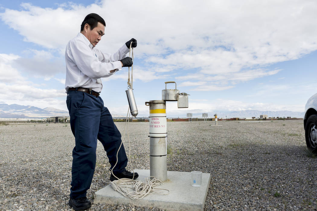 Water Quality Monitoring Field Specialist Daniel Luong utilizes a vessel to acquire a water sample from the 20 million water reservoir located at Montessori Street and Warm Springs Road, Las Vegas ...