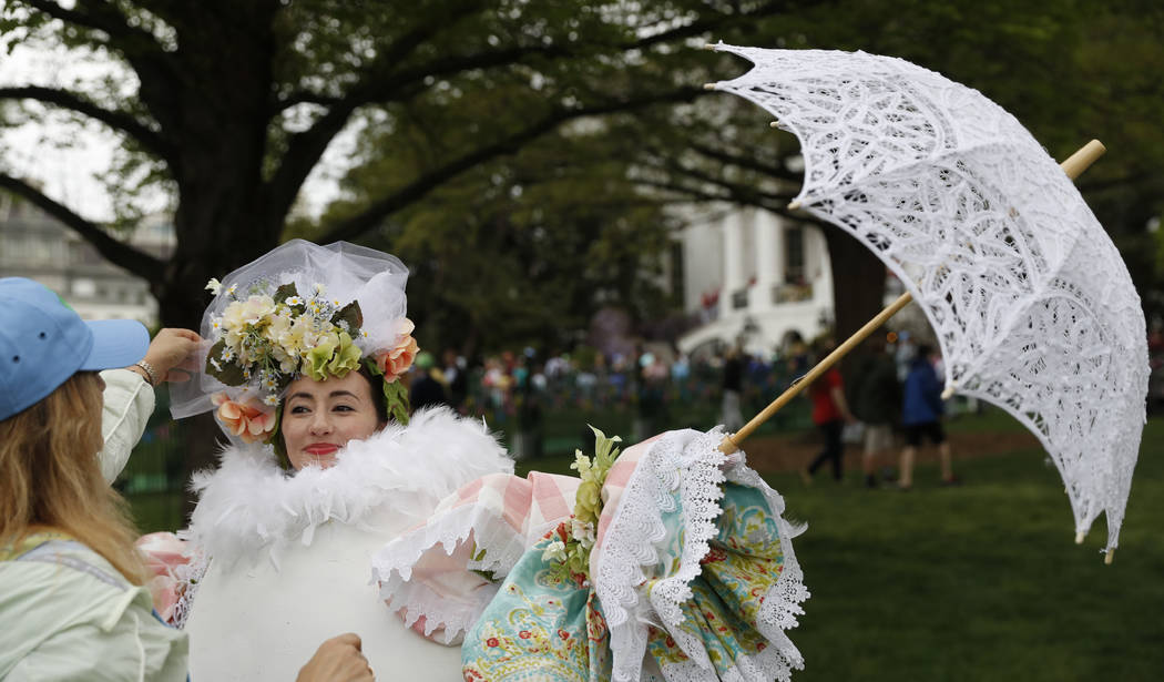 "Eggitha" from the Virginia Egg Council has her Easter bonnet straightened during the White House Easter Egg Roll on the South Lawn of the White House in Washington, Monday, April, 17, 2017. Presi ...