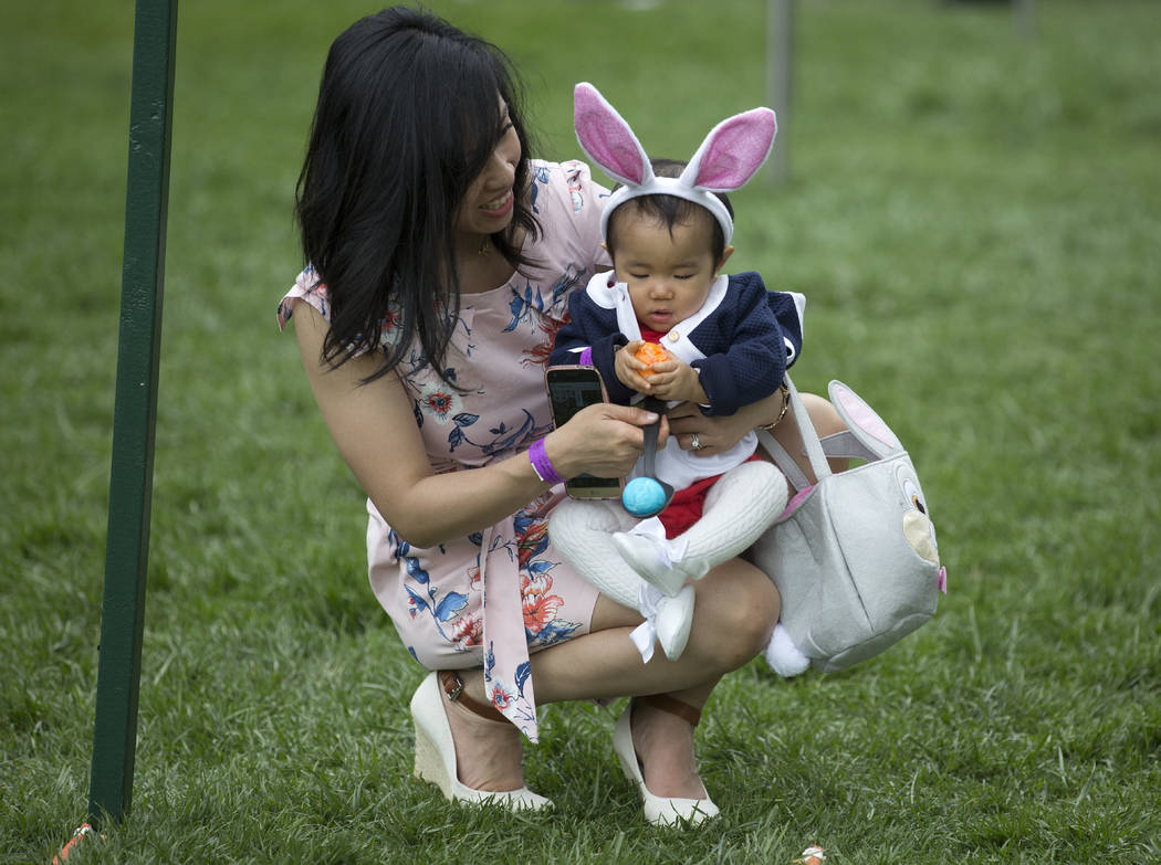 Eleven-month-old Victoria Cheng and her mother Guliana Cheng, both from San Francisco, prepare to participate in the White House Easter Egg Roll on the South Lawn of the White House in Washington, ...