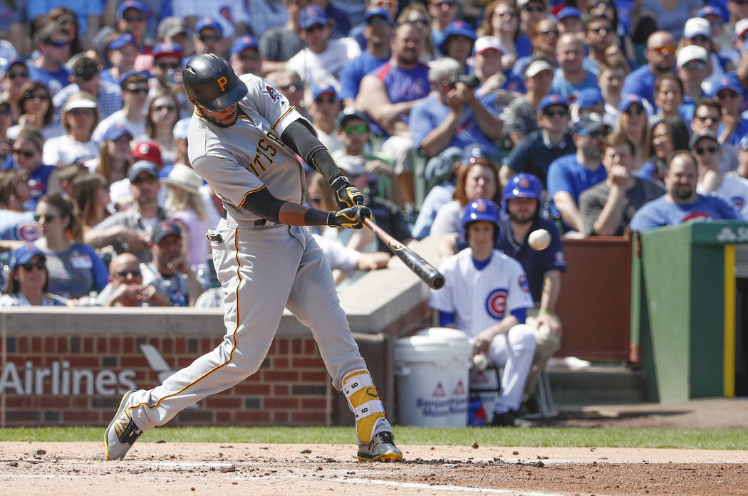 Pittsburgh Pirates center fielder Starling Marte hits an RBI-single off Chicago Cubs starting pitcher Jake Arrieta during the third inning of a baseball game, Saturday, April 15, 2017, in Chicago. ...