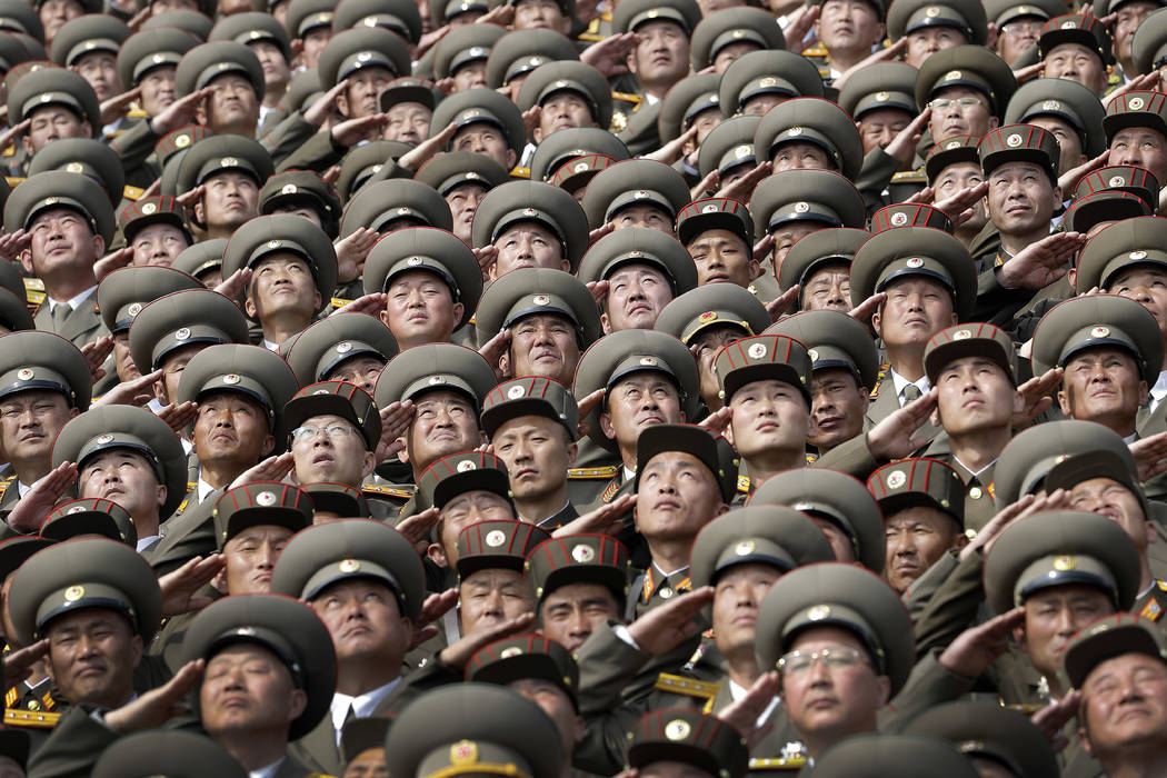 North Korean soldiers salute while the national anthem is played during a military parade on Saturday, April 15, 2017, in Pyongyang, North Korea to celebrate the 105th birth anniversary of Kim Il ...