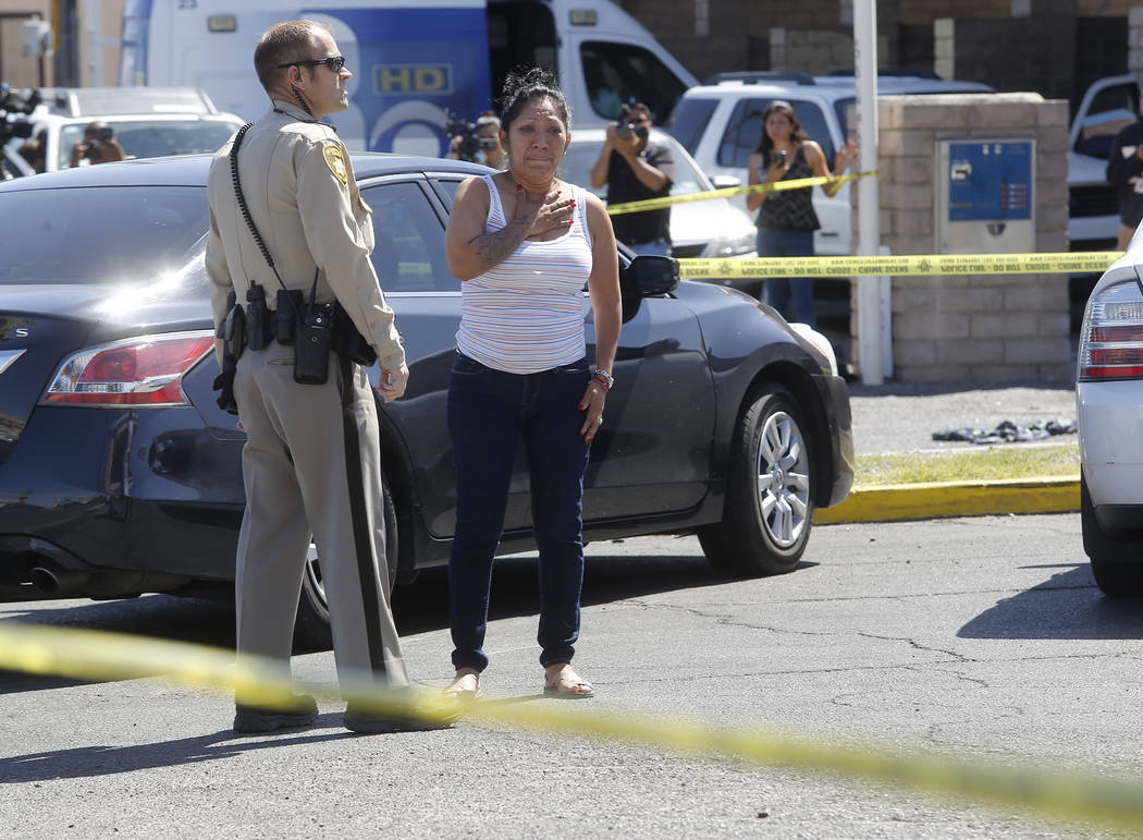 A lady reacts after arriving to a crime scene where a stabbing occurred at the Arco gas station located on Bonanza Rd. and N Lamb Blvd. on Wednesday, April 19, 2017, in Henderson. One person has d ...