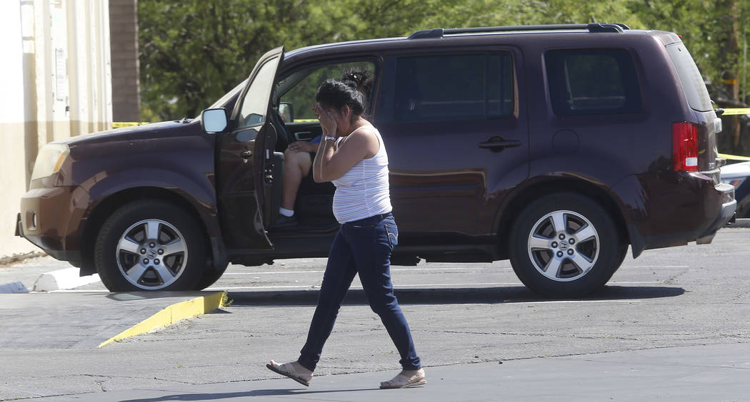 A lady reacts after arriving to a crime scene where a stabbing occurred at the Arco gas station located on Bonanza Rd. and N Lamb Blvd. on Wednesday, April 19, 2017, in Henderson. One person has d ...