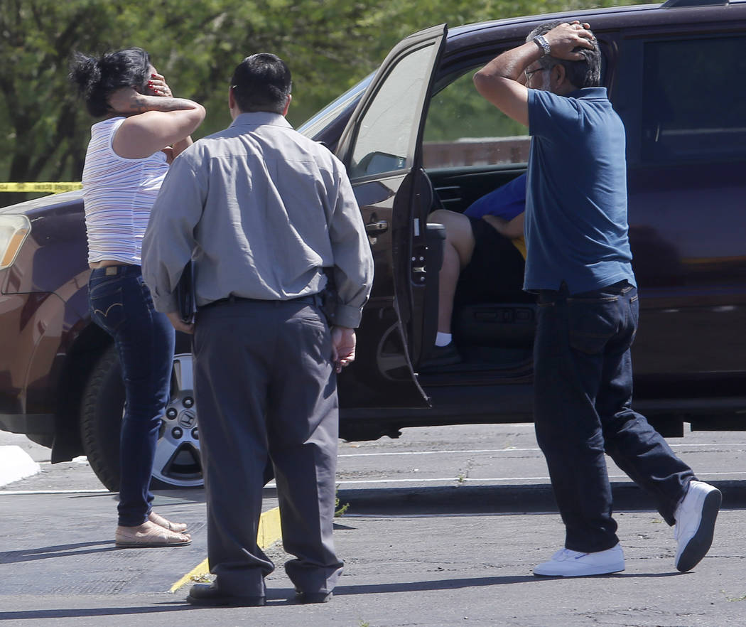 People react after arriving to a crime scene where a stabbing occurred at the Arco gas station located on Bonanza Rd. and N Lamb Blvd. on Wednesday, April 19, 2017, in Henderson. One person has di ...