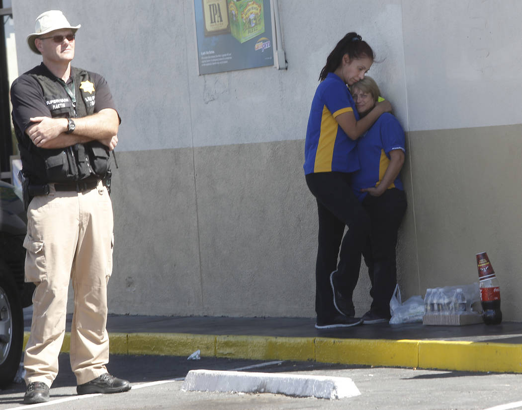 Arco gas station employees reacts to a crime scene where a stabbing occurred at the Arco gas station located on Bonanza Rd. and N Lamb Blvd. on Wednesday, April 19, 2017, in Henderson. One person  ...