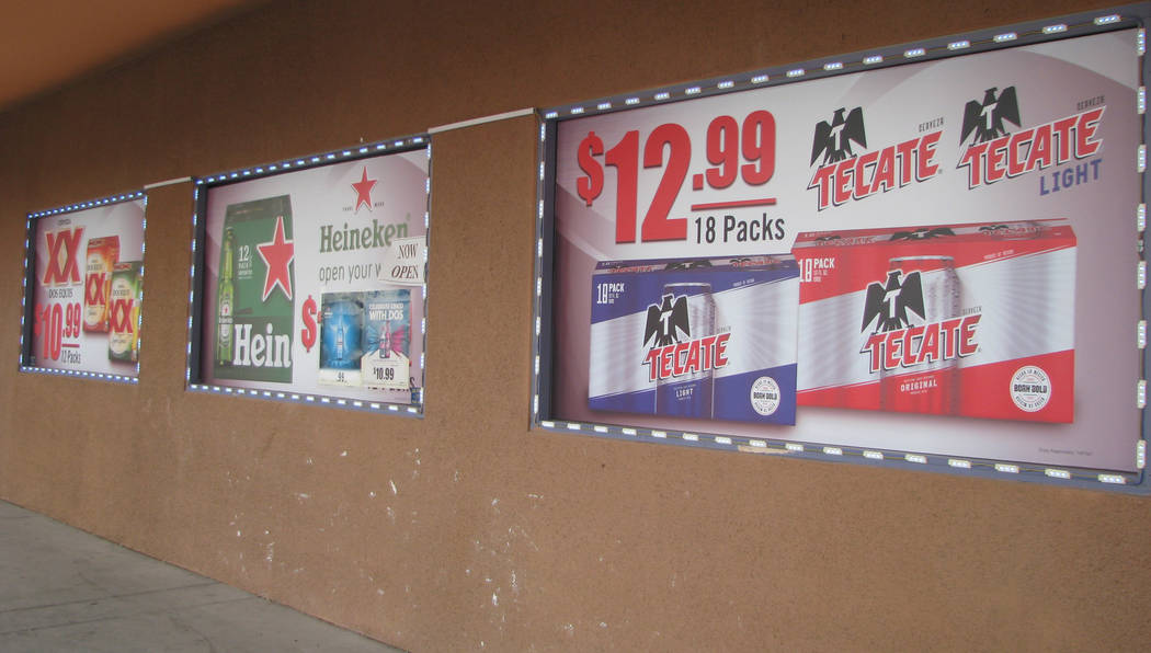 Every window of a market on Nellis Boulevard displays an advertisement for alcohol. (F. Andrew Taylor/View) @ FAndrewTPress