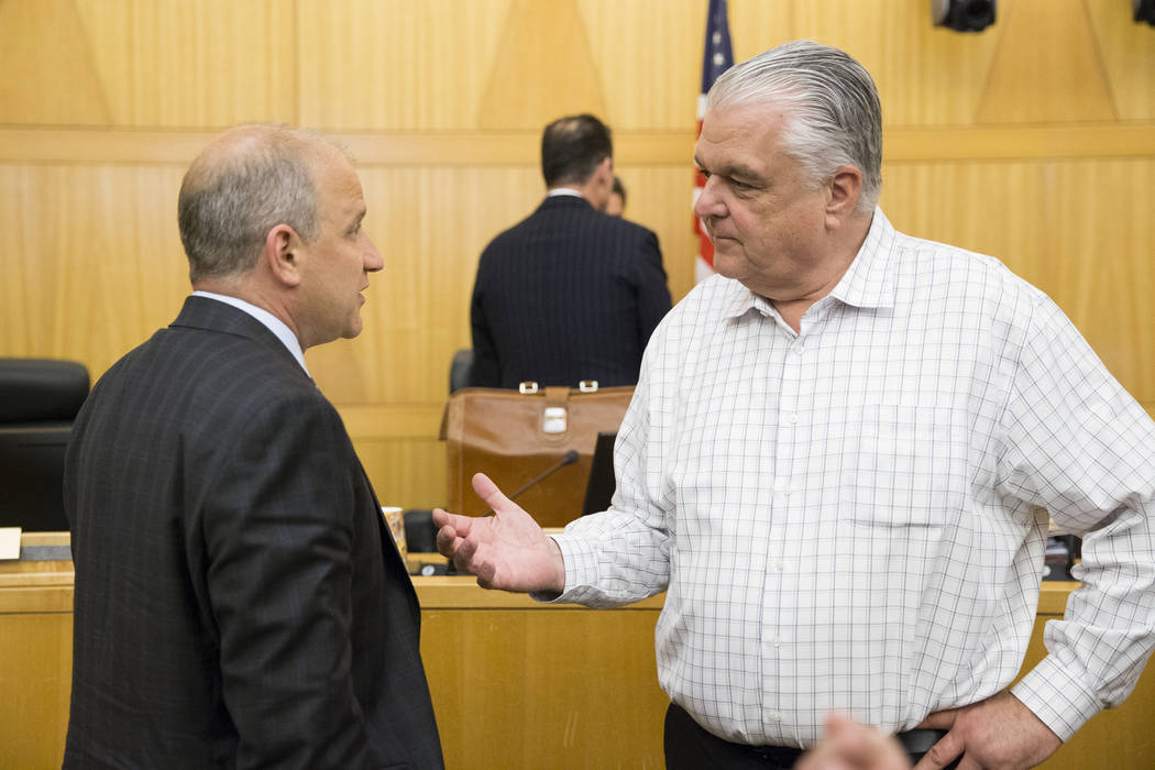 Oakland Raiders President Marc Badain, left, with Clark County Commissioner Steve Sisolak following a Las Vegas Stadium Authority board meeting at the Clark County Government Center on Thursday, A ...