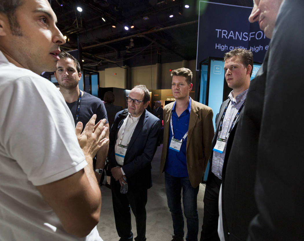 Strategic Product Manager for Ericsson, Daniel Martin Bernaldez, left, explains Ericsson's video analytics to participants at the National Association of Broadcasters exposition, the NAB Show, at  ...