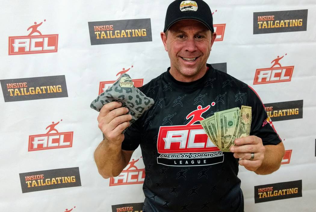 Cornhole player Eric Ryder and his winnings at the American Cornhole League tournament Cornhole for the Cure in Norfolk, Va. on March 4. (American Cornhole League)