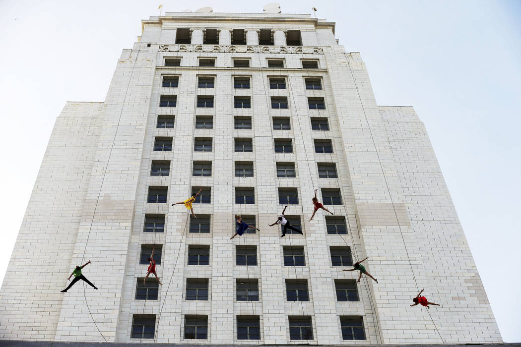 Dancers from Bandaloop aerial dance troupe perform to a medley of songs from the movie "La La Land" off the side of Los Angeles City Hall, during "La La Land Day" festivities Tuesday, April 25, 20 ...