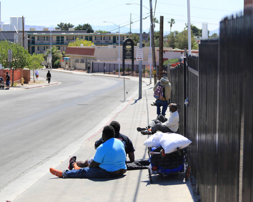 People sit on Foremaster Lane in Las Vegas, on Friday, April 28, 2017, in front of land that the city of Las Vegas wants to turn into a campus that will bring homeless providers together and give  ...