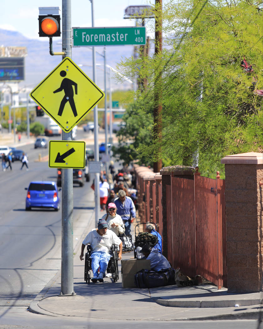 People walk along Main Street at Foremaster Lane in Las Vegas, on Friday, April 28, 2017, in front of land that the city of Las Vegas wants to turn into a campus that will bring homeless providers ...