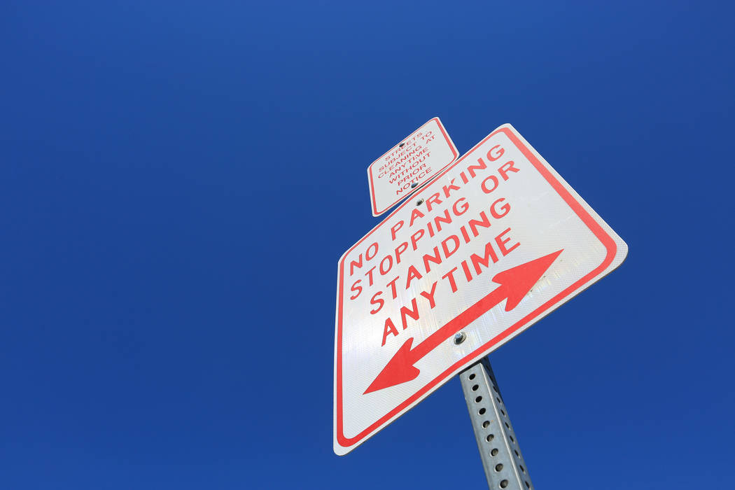 A sign warning people not to stop stand above the sidewalk on Foremaster Lane in Las Vegas, on Friday, April 28, 2017, in front of land that the city of Las Vegas wants to turn into a campus that  ...