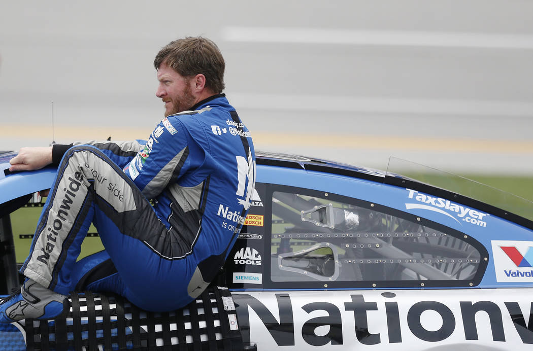 NASCAR driver Dale Earnhardt Jr. (88) gets out of his car during qualifying for Sunday's NASCAR auto race at Talladega Superspeedway, Saturday, April 30, 2016, in Talladega, Ala. (AP Photo/Brynn A ...