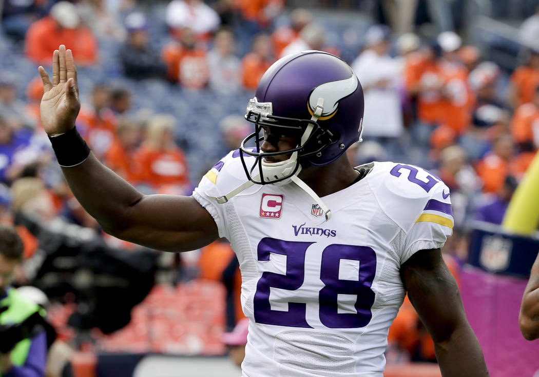 In this Oct. 4, 2015, file photo, Minnesota Vikings running back Adrian Peterson waves during warms ups before an NFL football game against the Denver Broncos, in Denver. Free-agent running back ...