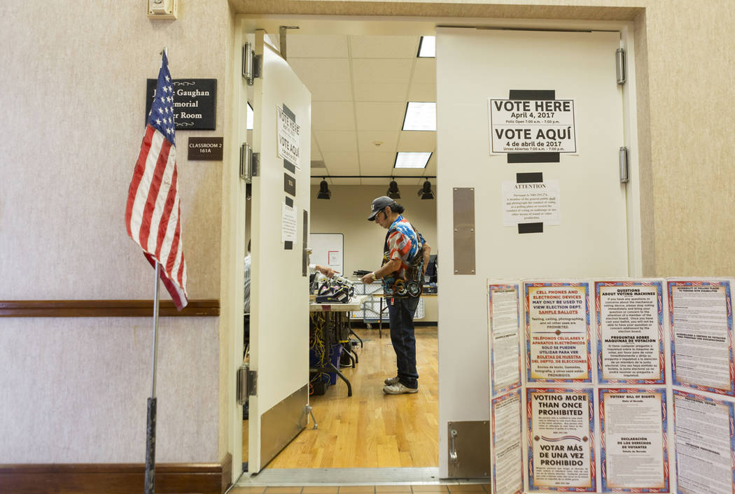 Robert Ranyan signs in to cast his ballot for the municipal primary elections at the East Las Vegas Community Center in Las Vegas on April 4. The Nevada Senate approved several election-related me ...