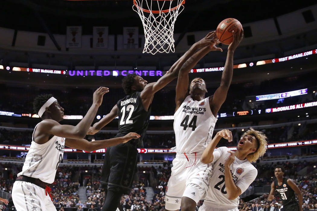 Big East's Mitchell Robinson (22) blocks the shot of Big West's Brandon L. McCoy (44) as Jaren Jackson Jr., left, and Brian "Tugs" Bowen II, watch during the second half of the M ...