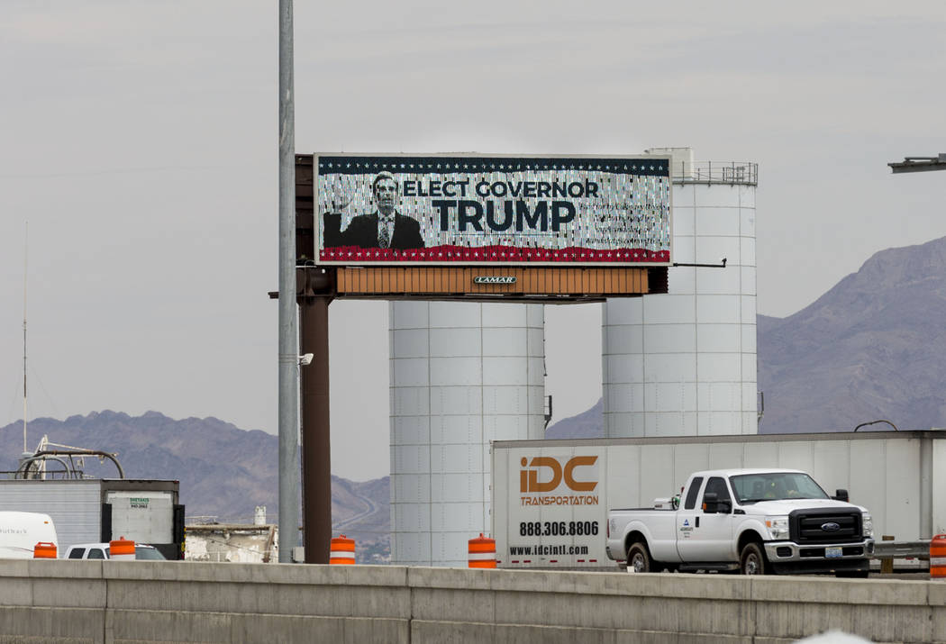A digital billboard off Interstate 15 in Las Vegas Tuesday compares Nevada Attorney General Adam Laxalt to President Donald Trump. Although he has not announced his intentions, Laxalt is said to b ...