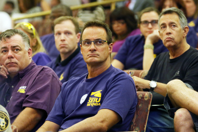 Service Employees International Union Local 1107 members and supporters, wearing purple shirts, wait for public comment to take place during the County Commission meeting at Clark County Governmen ...