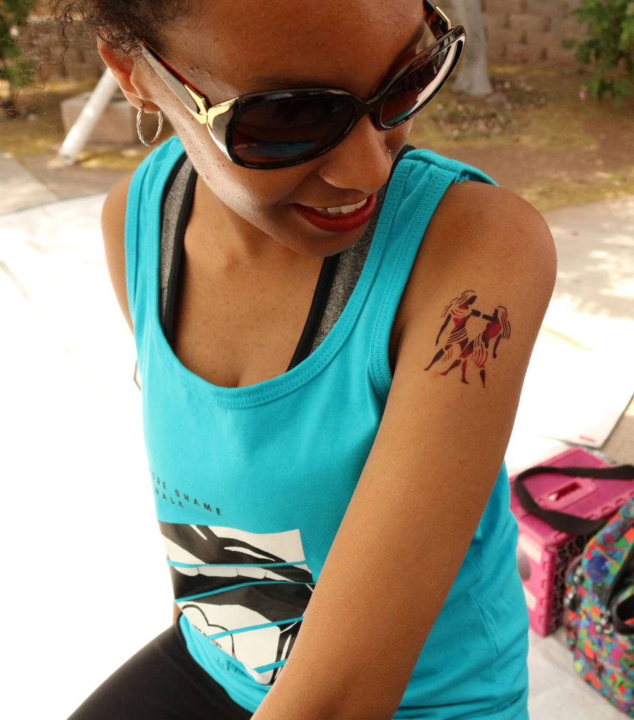 UNLV junior Eden Alem admires her temporary tattoo before &quot;No More Shame Slut Walk&quot; at the UNLV campus, Wednesday, April 26, 2017. Gabriella Benavidez Las Vegas Review-Journal @g ...