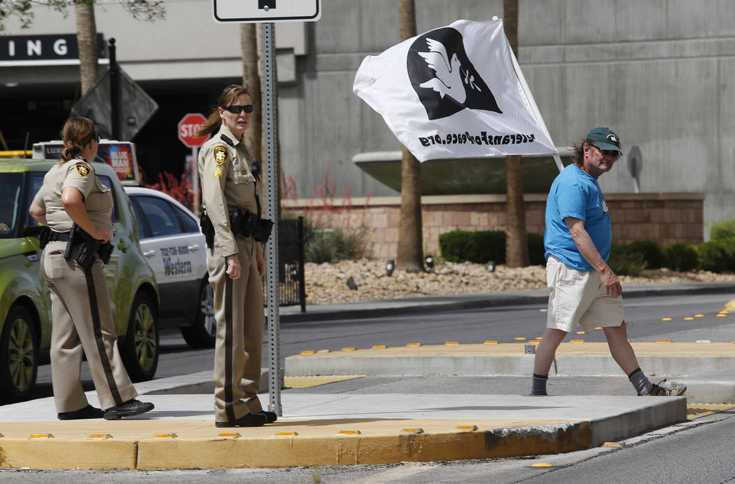 An anti-drone protester crosses the street to the Trump International Hotel on Thursday, April 27, 2017, in Las Vegas. Christian K. Lee Las Vegas Review-Journal @chrisklee_jpeg