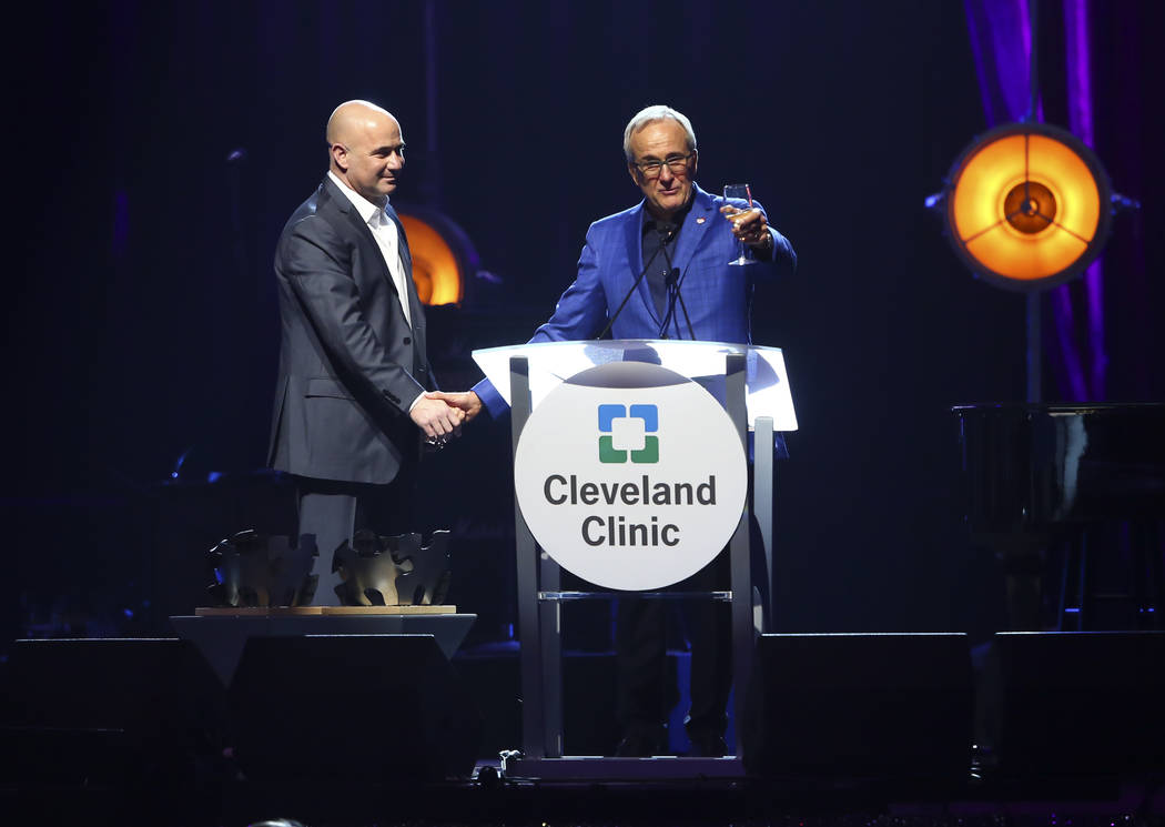 Larry Ruvo, co-founder and chairman of Keep Memory Alive, right, raises a glass alongside honoree Andre Agassi, a tennis great and Las Vegas resident, during Keep Memory Alive's 21st annual Power  ...