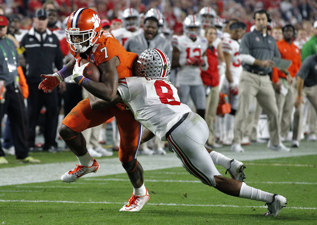 Clemson wide receiver Mike Williams (7) is stopped by Ohio State cornerback Gareon Conley (8) during the second half of the Fiesta Bowl NCAA college football game, Saturday, Dec. 31, 2016, in Glen ...