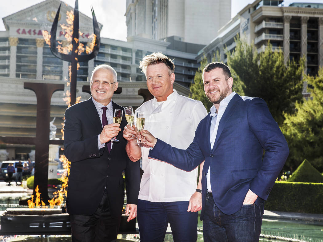 Caesars Palace president Gary Selesner, left, celebrity chef Gordon Ramsey and ITV America's Ed Simpson celebrate at the end of a press conference to announce Ramsey's new restaurant Gordon Ramsay ...