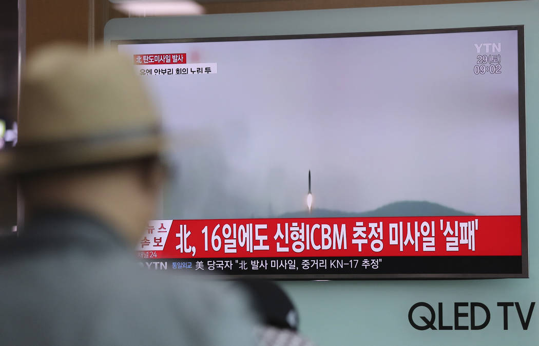 A man watches a TV news program reporting about North Korea's missile firing with a file footage, at Seoul Train Station in Seoul, South Korea, Saturday, April 29, 2017. The letters on top left re ...