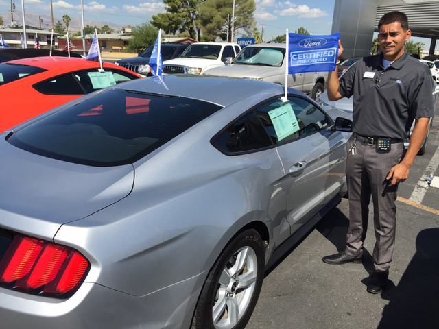 COURTESY FRIENDLY FORD
Friendly Ford sales consultant Xavier Damian is seen with a Ford certified pre-owned Mustang at the dealership at 660 N. Decatur Blvd.