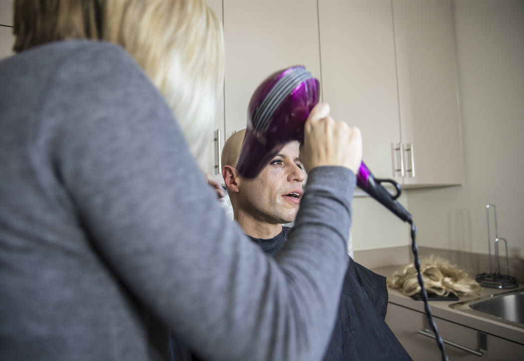 Dr. Zubin Damania, AKA "ZDoggMD," gets his makeup done by Lindsey Dimick before filming a scene parodying Kesha's hit song 'Tik Tok' on Sunday, April 9, 2017, at Damania's studio ...