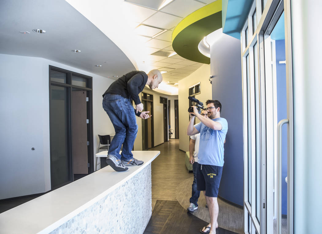 Dr. Zubin Damania, AKA "ZDoggMD," left, dances on the front desk at Turntable Health while director Tom Hinueber shoots footage on Wednesday, March 8, 2017, in Las Vegas. Dr. Da ...