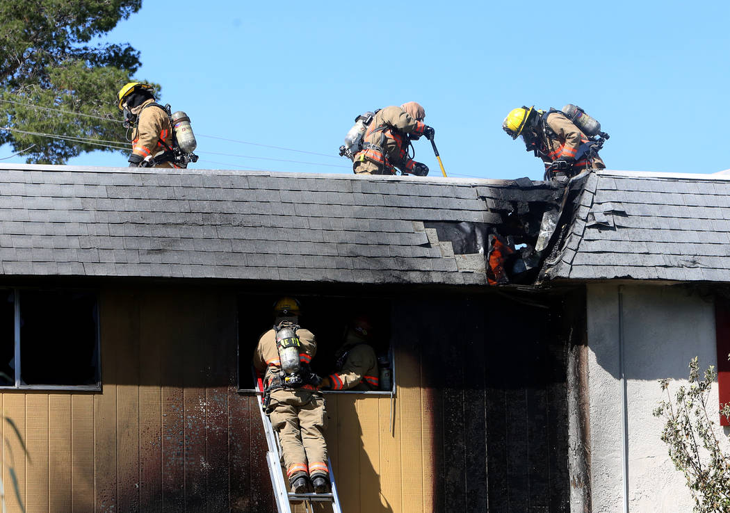 Clark County firefighters battle a fire at 741 and 743 Greenbriar Townhouse Way in Las Vegas on Wednesday, May 3, 2017. (Bizuayehu Tesfaye/Las Vegas Review-Journal) @bizutesfaye