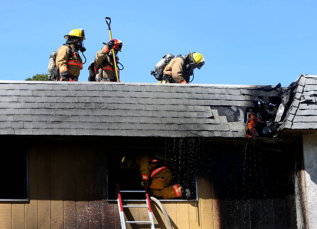 Clark County firefighters battle a fire at 741 and 743 Greenbriar Townhouse Way in Las Vegas on Wednesday, May 3, 2017. (Bizuayehu Tesfaye/Las Vegas Review-Journal) @bizutesfaye