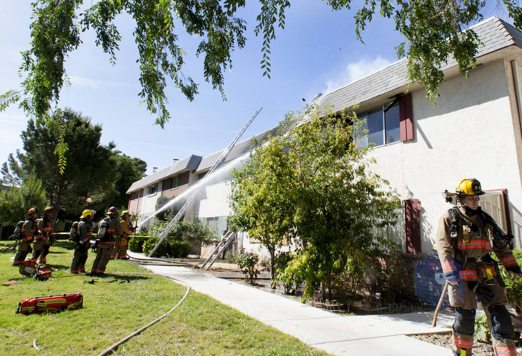 Clark County firefighters battle a fire at 741 and 743 Greenbriar Townhouse Way in Las Vegas on Wednesday, May 3, 2017. (Bizuayehu Tesfaye/Las Vegas Review-Journal) @bizutesfaye