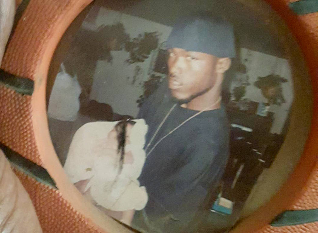 Jemar Matthews, as a teenager, holding his son. Photo provided by Tasha Page