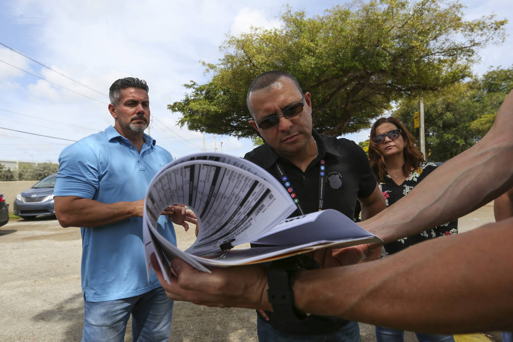 Miami-Dade Police Detective Daniel Garcia, far right,  briefs, from left, Lt. Carlos Gonzalez, public information officer Alvaro Zabaleta and Detective Ivette Perez before conducting an operation  ...