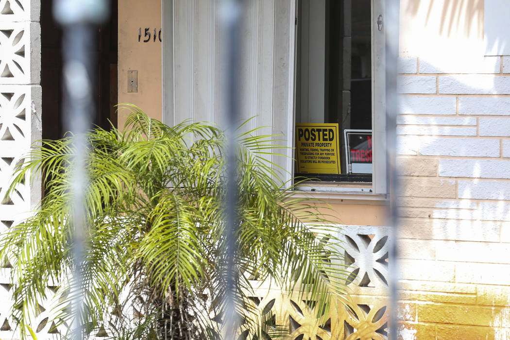 Signs were placed near the front entrance of a suspected squatter house in Miami, as seen Tuesday, April 18, 2017. Matias J. Ocner
